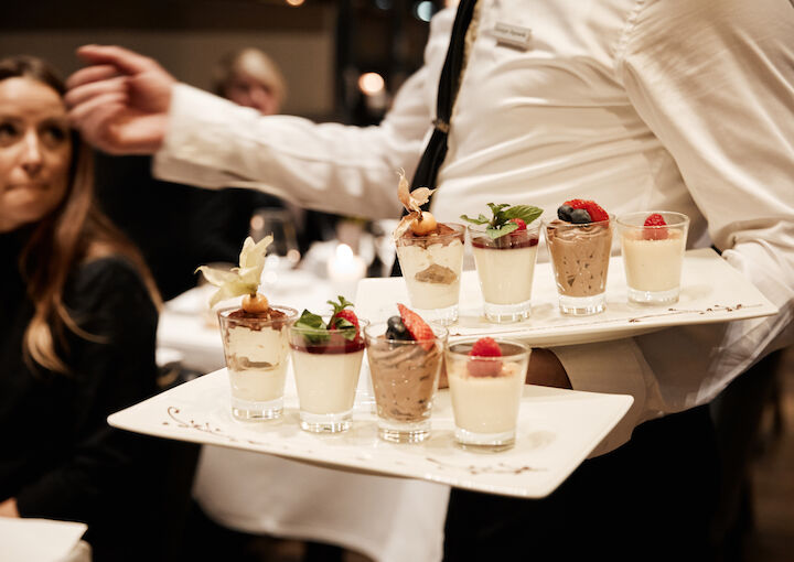 Various desserts being served by staff at DaCaio