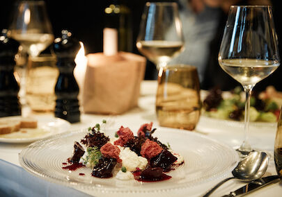 The George Hotel Hamburg Restaurant Dacaio food 19 Close up of burrata in the background a wine glass