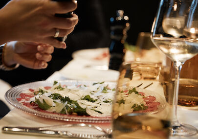 The George Hotel Hamburg Restaurant Dacaio 25 People Tartare in focus with person grinding pepper