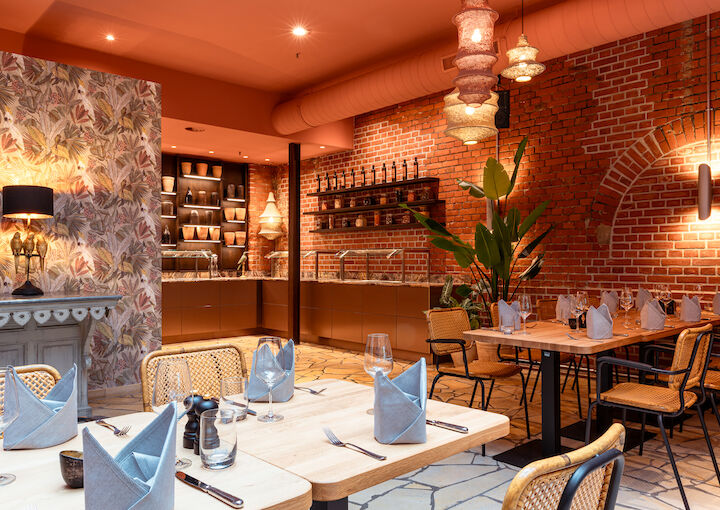 Winter garden detail with modern tables, buffet, brick walls and plants