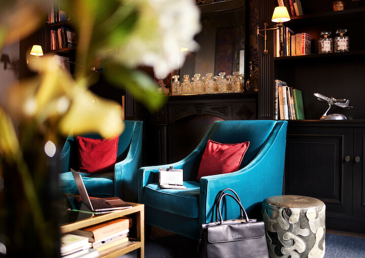 Library meeting room with two blue chairs and briefcase