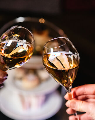 Two glasses of Champagne clink in celebration