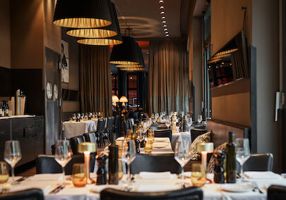 The George Hotel Hamburg Restaurant Dacaio 04 Close-up of beautifully set dinner tables in soft light