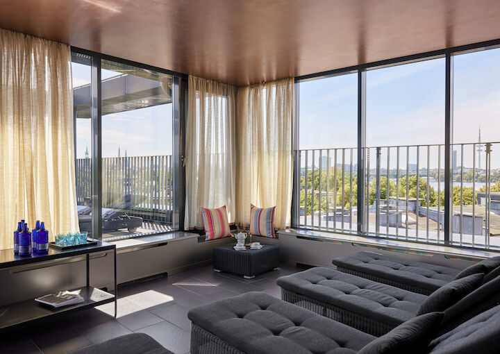 Relaxation loungers in sauna area with a view of Alster lake