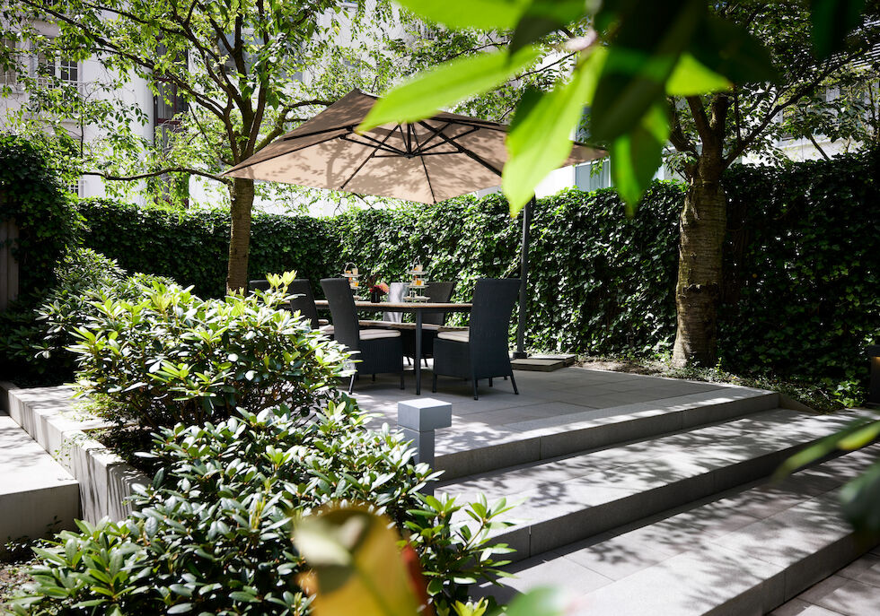 A garden next to the private library, featuring a large table