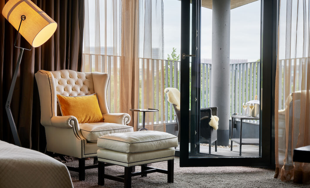 Chesterfield armchair with footstool, pointed balcony with seating behind