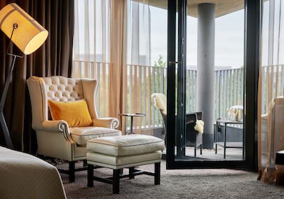 Chesterfield armchair with footstool, pointed balcony with seating behind