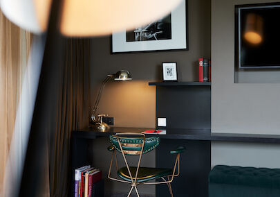 Desk with a green chair and a silver lamp