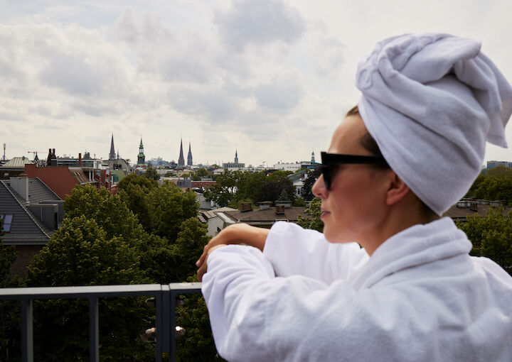 Women enjoys the view above Hamburg from spa terrace