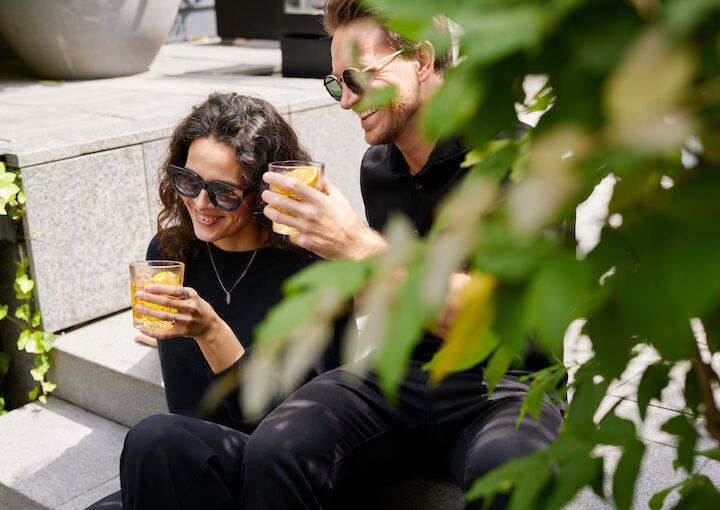 A Couple enjoys drinks in The George Garden
