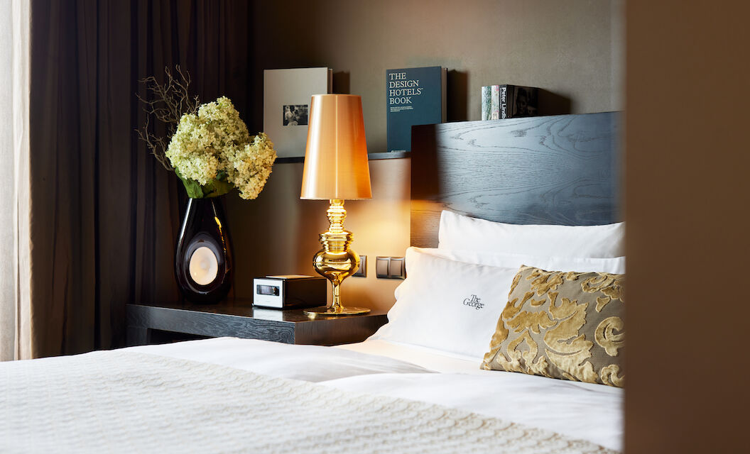 Side view of headboard with golden lamp and books in the background