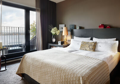 The George Suite with bed and large glass door to Alster view
