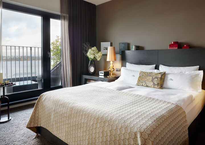 The George Suite with bed and large glass door to Alster view