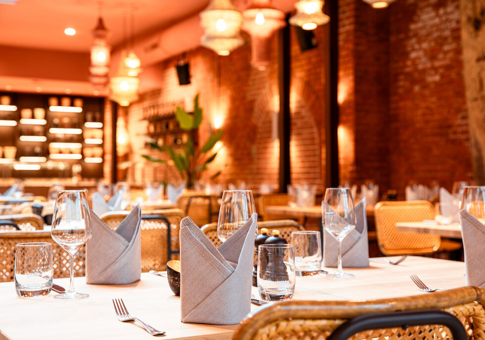 Tables in the conservatory set with elegant cloth napkins