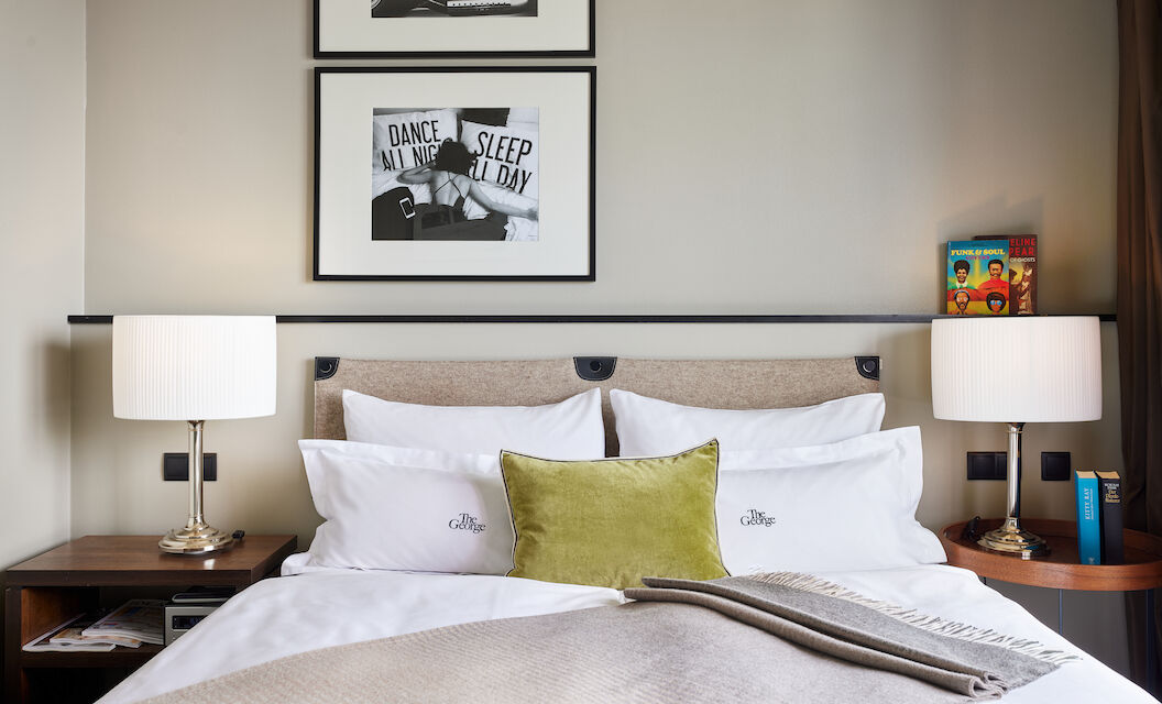 Double bed in room with Alster lake view, two decorative pictures on the wall