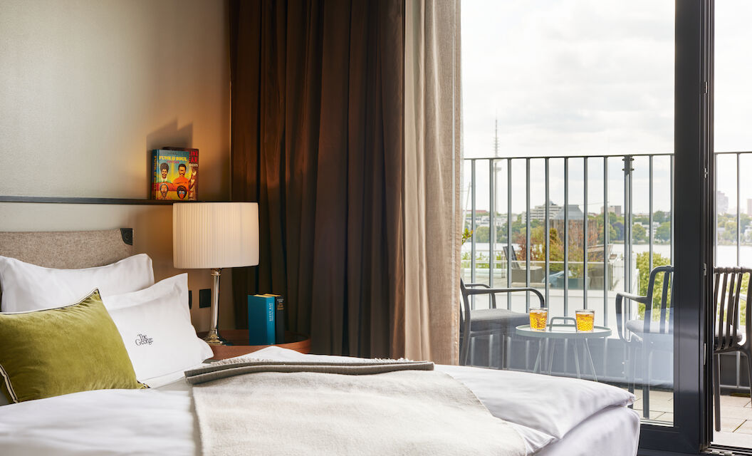 Double bed in foreground, window view outside towards the Alster