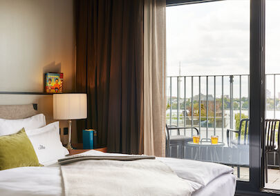 Double bed in foreground, window view outside towards the Alster