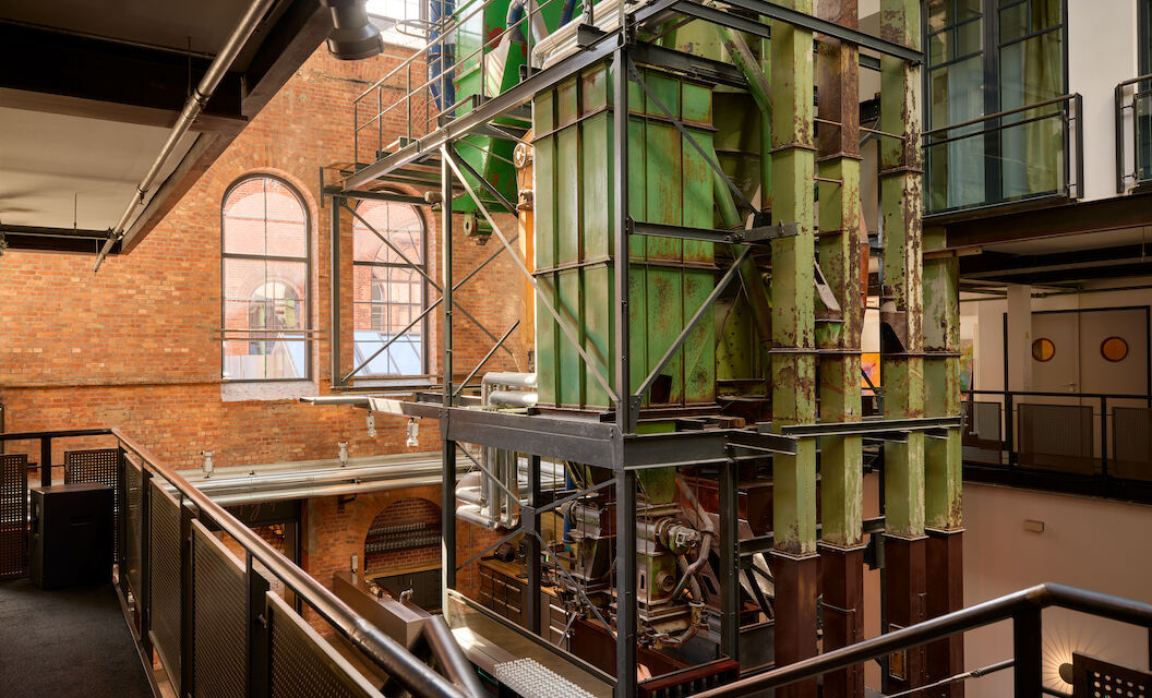 Lichtdurchflutete Denkmal Halle im Gastwerk Hotel Hamburg mit Industrie-Maschine im Vordergrund